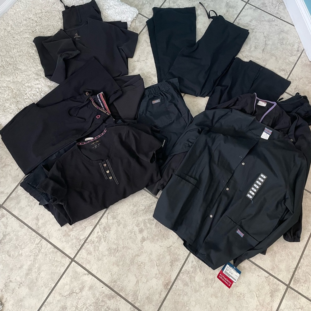 Lot of black scrubs. 5 bottoms 6 tops and 3 jackets one jacket still NWT.